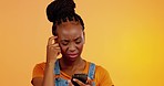 Confused, black woman and phone in a studio with mobile connection issue and problem. Head scratch, isolated and yellow background of a young female networking with online glitch feeling upset