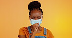 Covid face mask, cough or black woman sick via corona virus, studio health problem or flu disease. Healthcare crisis, medical emergency or portrait person with bacteria infection on orange background