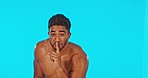 Bodybuilder, secret and face of a man with power, body and strong arms in studio. Isolated, blue background and portrait of a male model with fitness, exercise and workout motivation from training