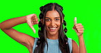 Thumbs up, down and face smile of woman on green screen in studio isolated on a background. Confused, portrait and happy Indian model or person with emoji for yes, no or agreement and disagreement.