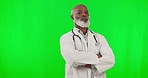 Arms crossed, doctor and face of a black man on a green screen isolated on a studio background. Serious, healthcare and portrait of an African gp looking strict about medical care with mockup