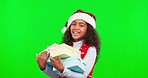 Christmas, presents and girl with green screen, face and happiness against a studio background. Portrait, young person and female child with Xmas gifts, excited and celebration for festive season