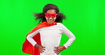 Portrait, justice and children with a superhero girl on a green screen background in studio standing hands on hips. Kids, costume and a happy female child hero playing fantasy as a crime fighter