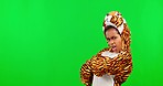 Green screen, cool and face of a child with arms crossed isolated on a studio background. Sassy, playful and portrait of a girl in a tiger costume with confidence on a mockup backdrop with space