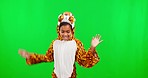 Costume, dance and face of a girl on a green screen isolated on a studio background. Fun, playful and portrait of a child dressed as a tiger dancing and being funny on a backdrop with mockup