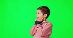 Mockup, wow and boy with green screen, surprise and happiness on a studio background. Young person, kid and male child with shock, touching face and cheerful with space, excited and facial expression