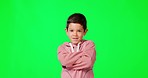 Child, arms crossed and smile by green screen, studio and happy with confidence, youth or face by background. Boy, kid and happiness for attitude, excited and portrait in chromakey mockup with energy