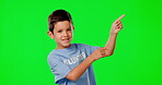 Pointing, volunteer and idea with child in green screen studio for product placement, spa and mockup. Positive, charity and help with portrait of  boy on background for show, support and suggestion