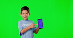 Green screen, phone and volunteer child pointing to mockup space for ngo or nonprofit advertising isolated on studio background. Kid with cellphone or mobile app tracking marker for charity support