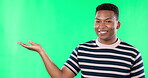 Promotion, Green screen and black man showing open hand or mockup space isolated in a studio background with a smile. Excited, advertising and portrait of male showing brand placement, deal or sale