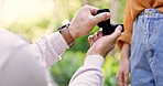 Hands, engagement and question with a man asking a woman, will you marry me, in a garden during summer. Love, romance and ring in a box with a couple bonding on a date in a park together closeup