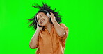 Green screen, woman and dance to excited music in studio, freedom or fun celebration in good mood. Headphones, happy female model and dancing to audio, sound or energy for listening to disco on radio