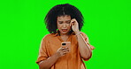 Sad, phone and crying with woman on green screen for breakup, social media or depression. Bad news, Communication, text message and technology with female on studio background for emotion and anxiety