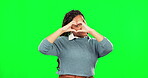 Face, heart and hands of happy woman on green screen, studio and background for hope. Portrait, female model and finger sign of love, support and kindness for care, emoji and icon of peace and trust