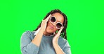 Sunglasses, face and woman in a studio with green screen with a happy pout facial expression. Portrait of an African female model with a trendy, cool and stylish accessory by a chroma key background.