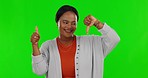 Green screen, review and black woman with a thumbs up or down isolated on a studio background. Decision, smile and face portrait of an African girl with a choice between hand gesture for an opinion