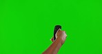 Hand, remote control and green screen, change channel and watching tv with technology and entertainment. Device, digital and person with streaming option, subscription and mockup on studio background
