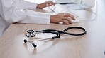 Closeup, stethoscope or medical tools on desk in hospital for healthcare, examination and listening. Equipment, health and tech to listen to heart, breathing and lungs in clinic office with doctor