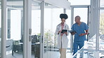 Leaving, tablet and doctors walking and talking together about medicine in a modern hospital having a discussion. Checklist, clipboard and team of medical healthcare professionals in communication