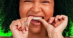 Woman, face and dental flossing on green screen for healthcare or hygiene against a studio background. Closeup of happy female cleaning teeth for healthy fresh, gum care or oral and mouth treatment