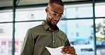 Morning, black man and walking, greeting and hello in office before sitting at a desk to check documents. Work, arrival and African male financial advisor excited, happy and ready for productivity 