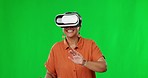 Virtual reality, technology and woman in studio with green screen playing a video game with headset. Vr, metaverse and senior female model moving with goggles while isolated by chroma key background.