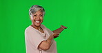 Face, green screen and woman presenting, smile and product placement against studio background. Portrait, senior female or mature person with happiness, showing to the back or selection with decision