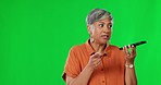 Speaker, phone call and elderly woman in green screen studio for conversation on mockup background. Voice to text, note and senior lady talking, planning or share interesting gossip or recording memo
