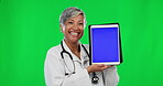 Woman, doctor and tablet mockup on green screen with tracking markers against studio background. Portrait of happy senior female medical expert showing touchscreen display in Telehealth on copy space