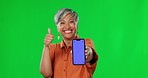 Woman, phone and thumbs up with mockup on green screen and tracking markers against a studio background. Portrait of happy senior female showing thumb emoji, yes sign or like with smartphone display