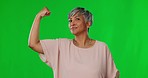 Face, green screen and senior woman flex arm, power and confident against a studio background. Portrait, mature female flexing and person with empowerment, muscle and success with motivation or fight