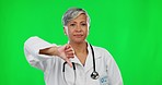 Review, green screen and face of a doctor wuth a thumbs down isolated on a studio background. Unhappy, mature and a woman in healthcare with a gesture of disapproval, disappointment or bad news
