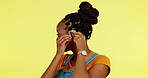 Portrait, hearing aid and thumbs up with a black woman on a yellow background saying yes or thank you. Deaf, disability and like hand gesture with a happy young female feeling positive or cheerful