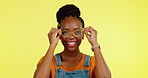 Black woman, face and glasses with happiness, vision and eye care with prescription lens on yellow studio background. Mockup, happy female in portrait and designer frame, fashion eyewear and smile