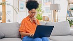 Laptop, thinking and woman typing on sofa in home living room, working or social media. Computer, remote worker and happy mixed race person or freelancer writing email, research or online browsing.