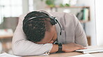 Tired black man, call center and sleeping on desk in burnout, insomnia or stress at office. Exhausted African American male consultant or agent asleep at help desk in customer service at workplace