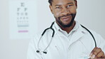 Optometry, vision and a man cleaning glasses in a clinic for an eye test to check for prescription lenses. Portrait, face and smile with a happy african doctor wiping eyewear in an optician office