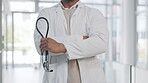 Doctor, man and arms crossed, confidence and pride with healthcare and surgeon in hospital with stethoscope. Male physician, cardiovascular health and medical professional with expert in medicine
