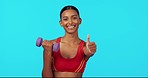 Fitness, woman and weightlifting dumbbell with thumbs up for success, workout or exercise against blue studio background. Portrait of happy or fit female lifting weight showing thumb emoji on mockup