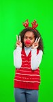 Christmas, green screen and child with peace sign for happy festive season, holiday or celebration with red nose. Oops, chroma key portrait and female kid with emoji icon gesture on studio background