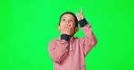 Green screen, child and boy with surprise, pointing up and happiness against a studio background. Male kid, young person and youth with shock, direction and space with choice, decision or opportunity