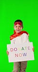 Green screen, superhero and child with poster for donation, charity and volunteer service in studio. Help mockup, support and portrait of boy in costume with sign, billboard and banner to donate now