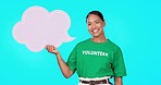 Face, woman and volunteer with a smile, speech bubble and communication on a blue studio background. Portrait, female activist and person with paper, branding and product placement for social media