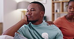 Couple, upset and a woman comforting her boyfriend in the living room of their home for support, love or care. Sad, trust and an african female showing empathy to her partner during grief in a house