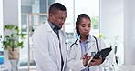 Teamwork, tablet and doctors in discussion in hospital for medical results, consulting and research. Healthcare, clinic and black man and woman on digital tech for wellness, telehealth and analysis