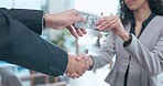 Business people, handshake and money for deal, bribe or agreement in corporate partnership or meeting at office. Woman shaking hands with businessman in cash payment, exchange or bribery at workplace