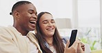 Phone, laughing and couple relax in home living room, bonding and streaming comedy movie. Interracial, cellphone and happy black man and woman watching funny video, meme or social media together.