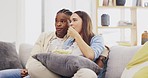 Couple, watching tv and eating popcorn in home, bonding and relax on sofa in living room. Television, interracial and black man and woman streaming movie, video or film while chewing food or snack.