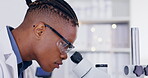 Science, microscope and experiment with a doctor man at work in a laboratory for innovation or breakthrough. Medical, sample and zoom with an african male scientist working in a lab for research