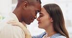 Hug, happy and an interracial couple in an embrace for love, gratitude and appreciation at home. Smile, together and a black man and woman hugging, embracing and being affectionate for closeness